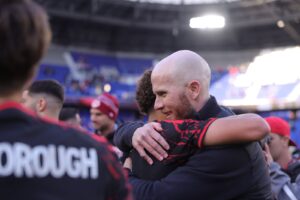 Red Bull New York head coach Michael Bradley celebrates New York's victory with his players.
