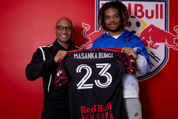 Red Bull New York head of sport Julian de Guzman poses with defender Joyeux Masanka Bungi.