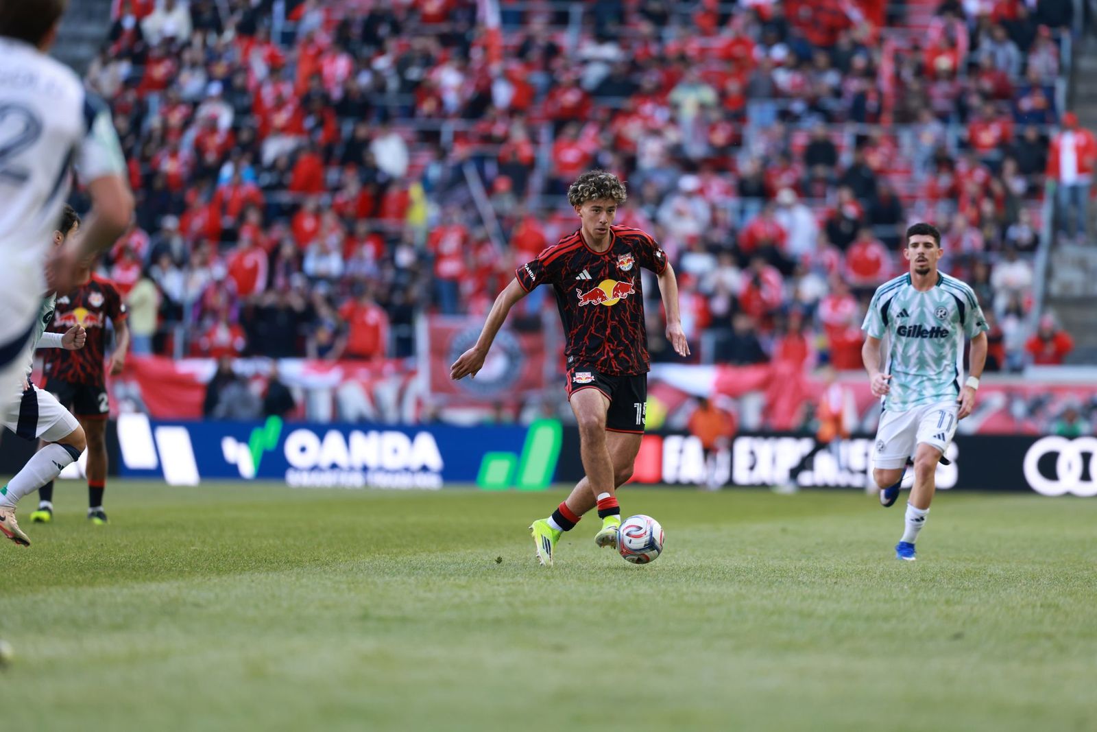 Red Bull New York midfielder Adri Mehmeti dribbles against the New England Revolution.