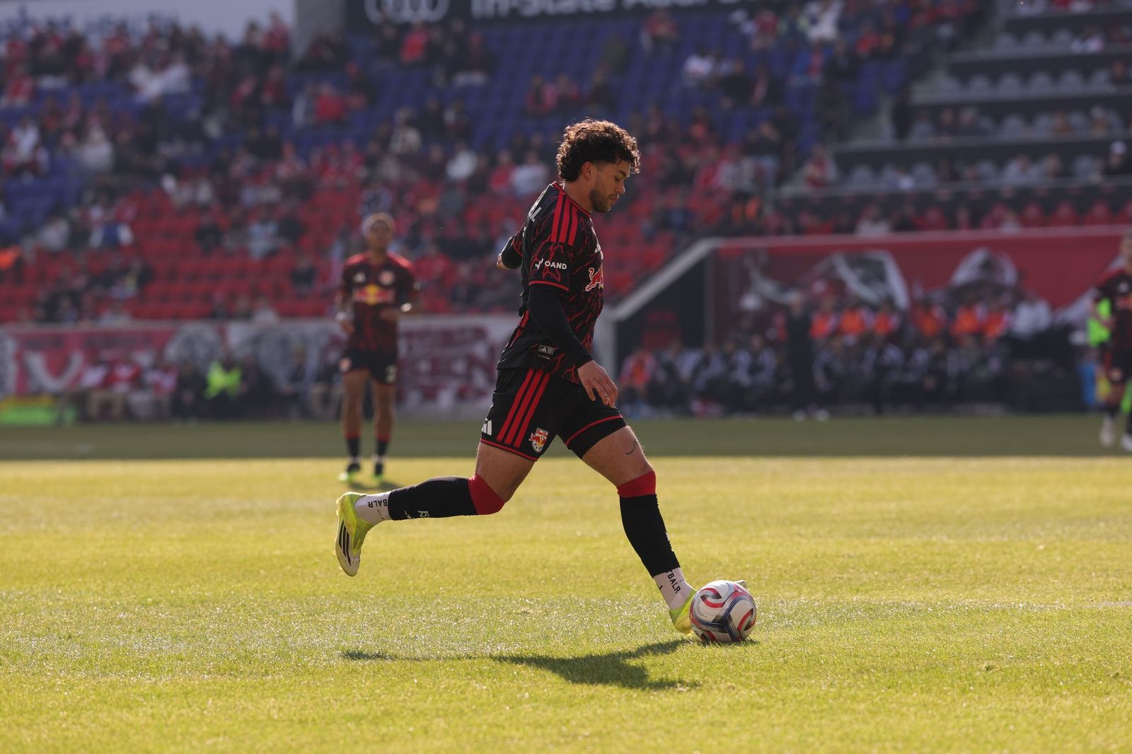 Red Bull New York winger Cade Cowell attempts a cross at Sports Illustrated Stadium.