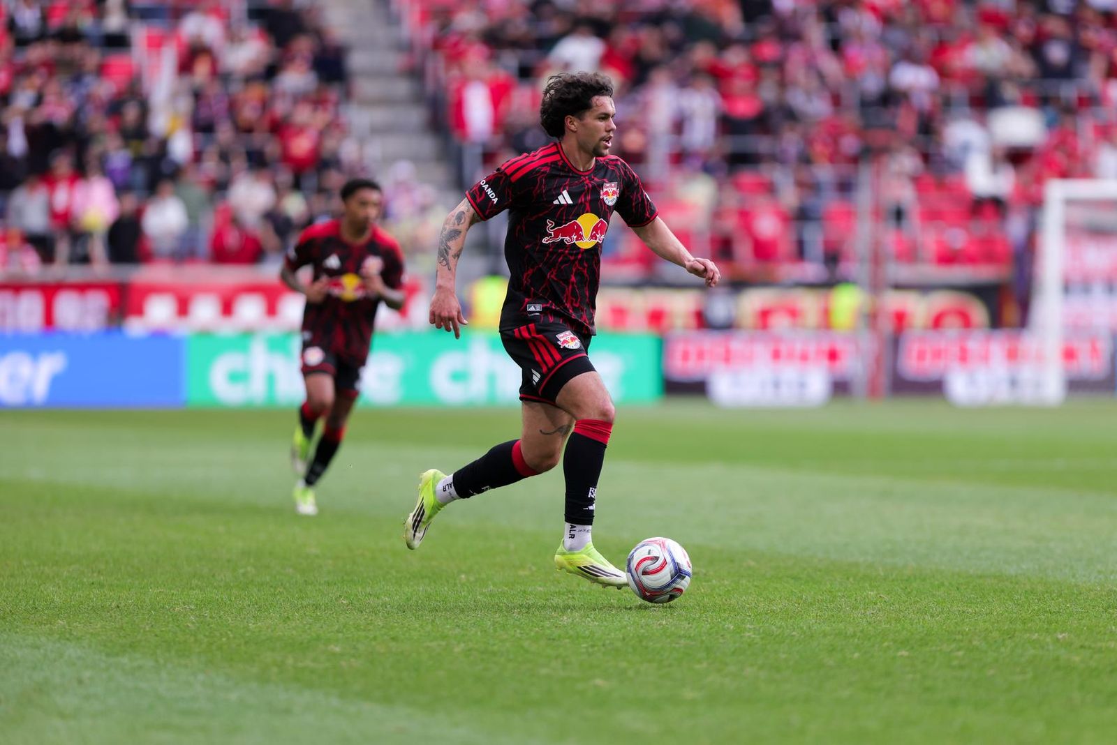 Red Bull New York winger Cade Cowell dribbles the ball at Sports Illustrated Stadium.
