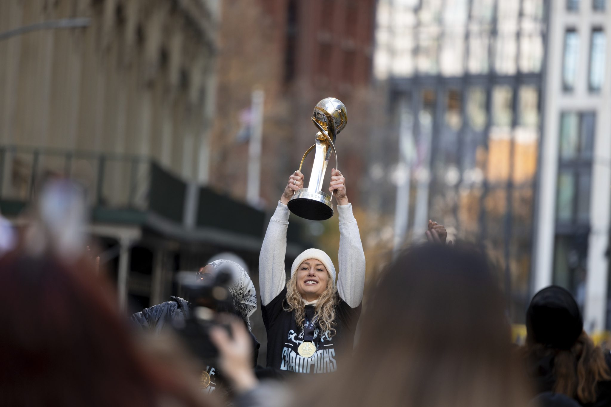 Gotham FC midfielder Jaelin Howell holds aloft the NWSL Championship trophy in Manhattan.