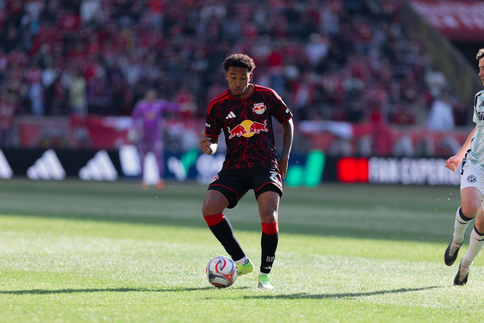 Red Bull New York defender Jahkeele Marshall-Rutty passes the ball.