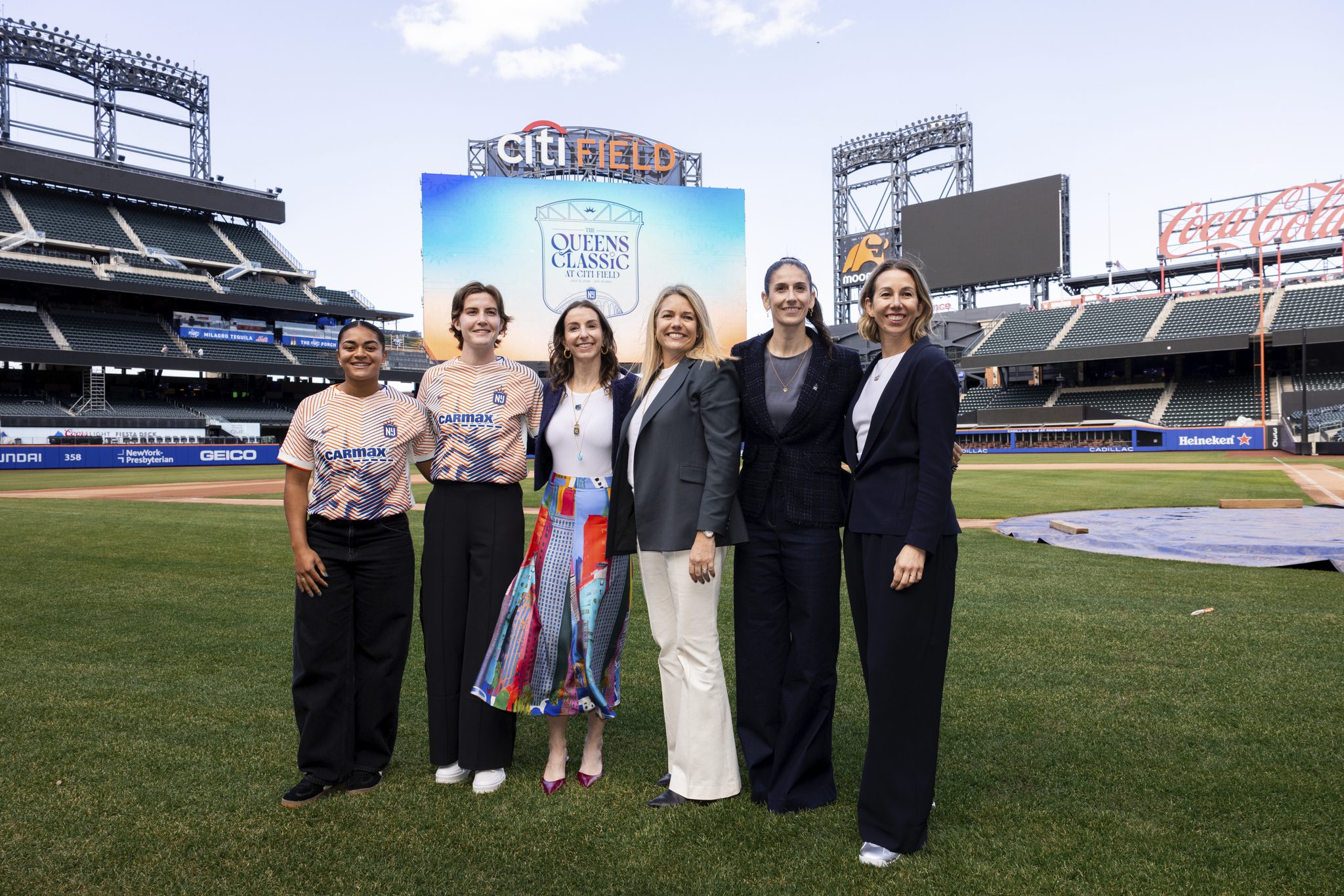 Gotham FC defender Jess Carter, captain Tierna Davidson, Gotham FC owner and governor Carolyn Tisch Blodgett, New York Mets EVP of Ballpark Operations Katie Haas, Gotham general manager Yael Averbuch West and  NWSL COO Sarah Jones Simmer at the press conference for the Queens Classic.