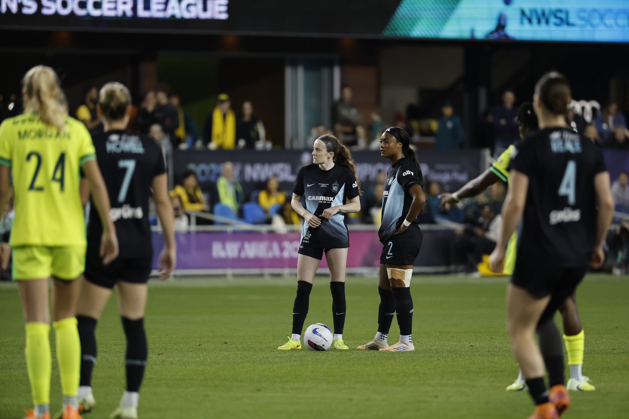 Gotham FC teammates Rose Lavelle and Jaedyn Shaw stand over the ball before a free kick.