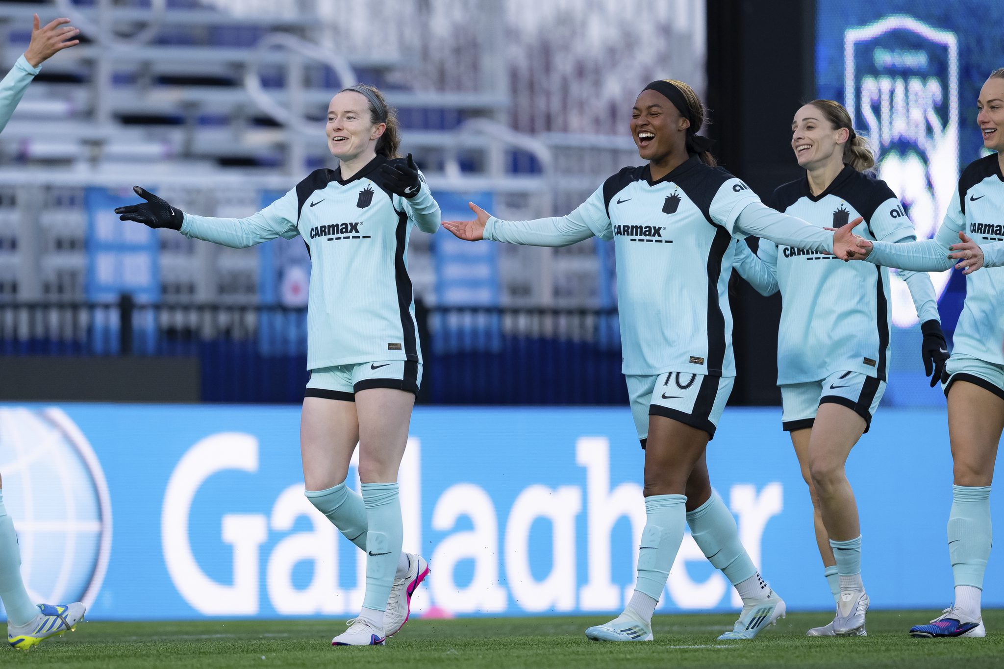 Gotham FC teammates celebrate together.
