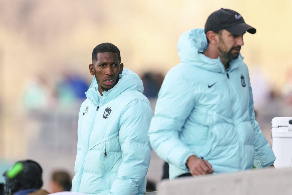 Gotham FC lead assistant coach Shaun Harris interacts with technical staff.