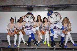 Gotham FC players pose in the Citi Field dugout with New York Mets mascots Mr. and Mrs. Met.