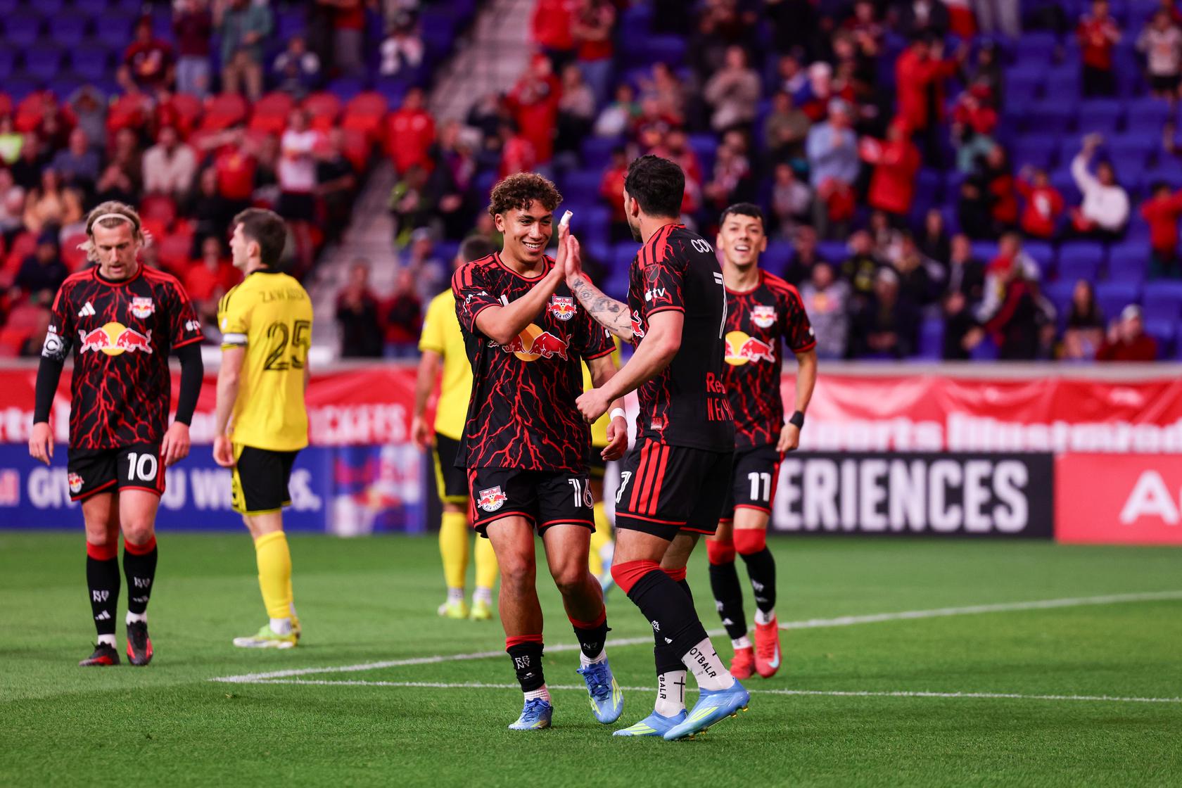 Red Bull New York teammates Julian Hall and Cade Cowell and Jorge Ruvalcaba celebrate together.