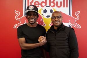 Red Bull New York midfielder Ronald Donkor embraces head of sport Julian de Guzman.