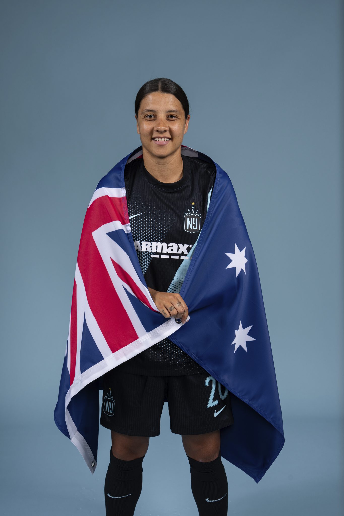 Gotham FC forward Sam Kerr photographed with an Australia flag.