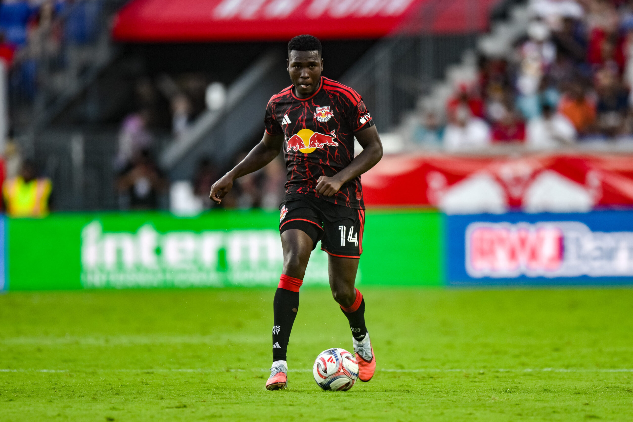 Red Bull New York defender Julián Bazán dribbles the ball against Charlotte FC during the second half at Sports Illustrated Stadium.