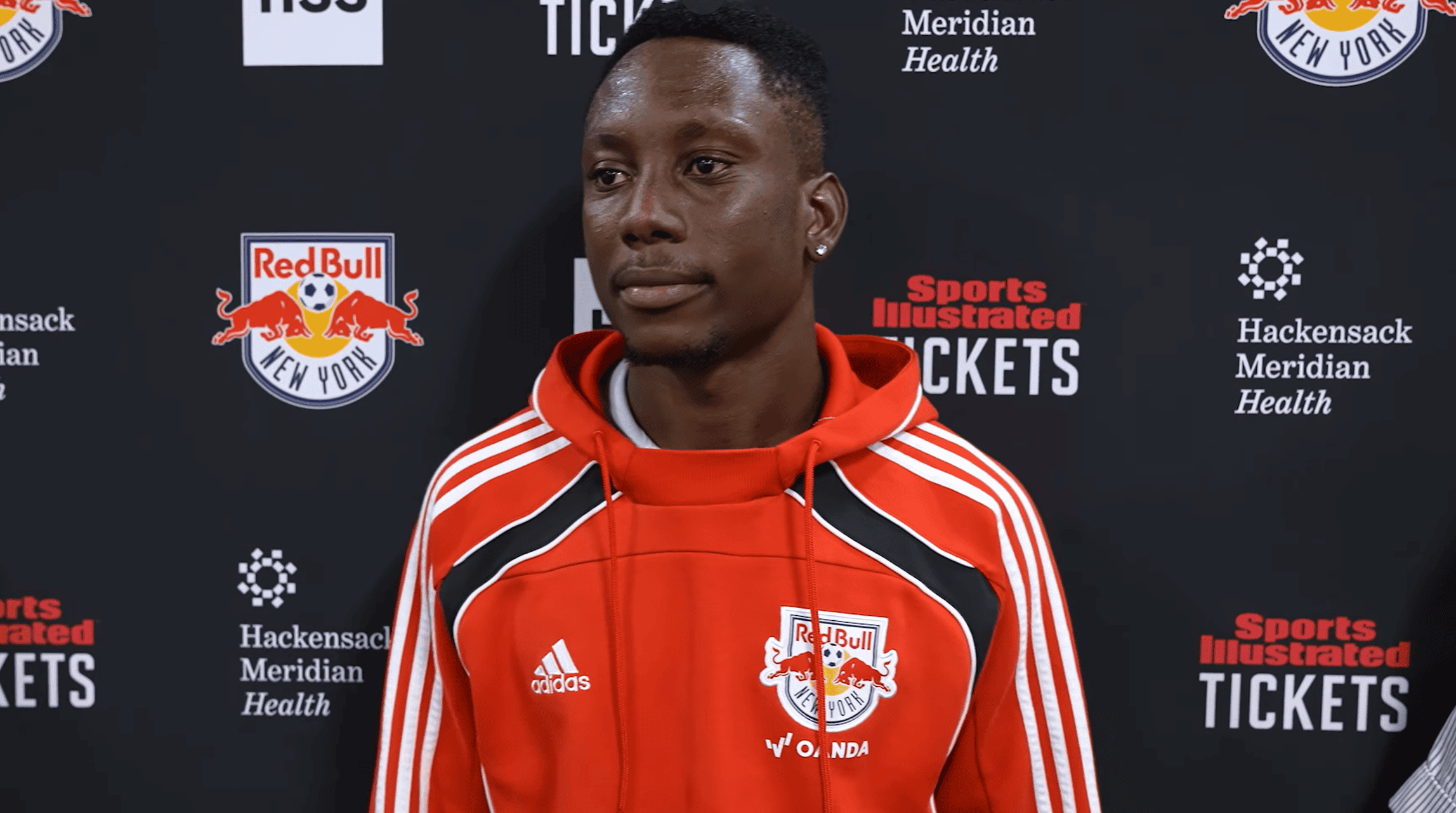 Red Bull New York midfielder Ronald Donkor is interviewed by reporters following a match.