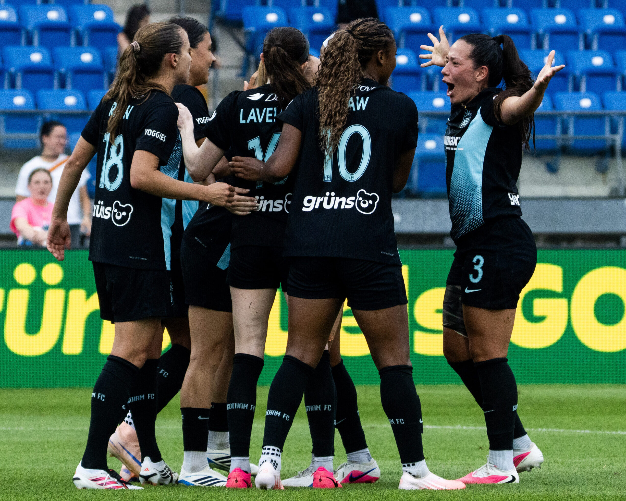 Gotham FC teammates celebrate together.
