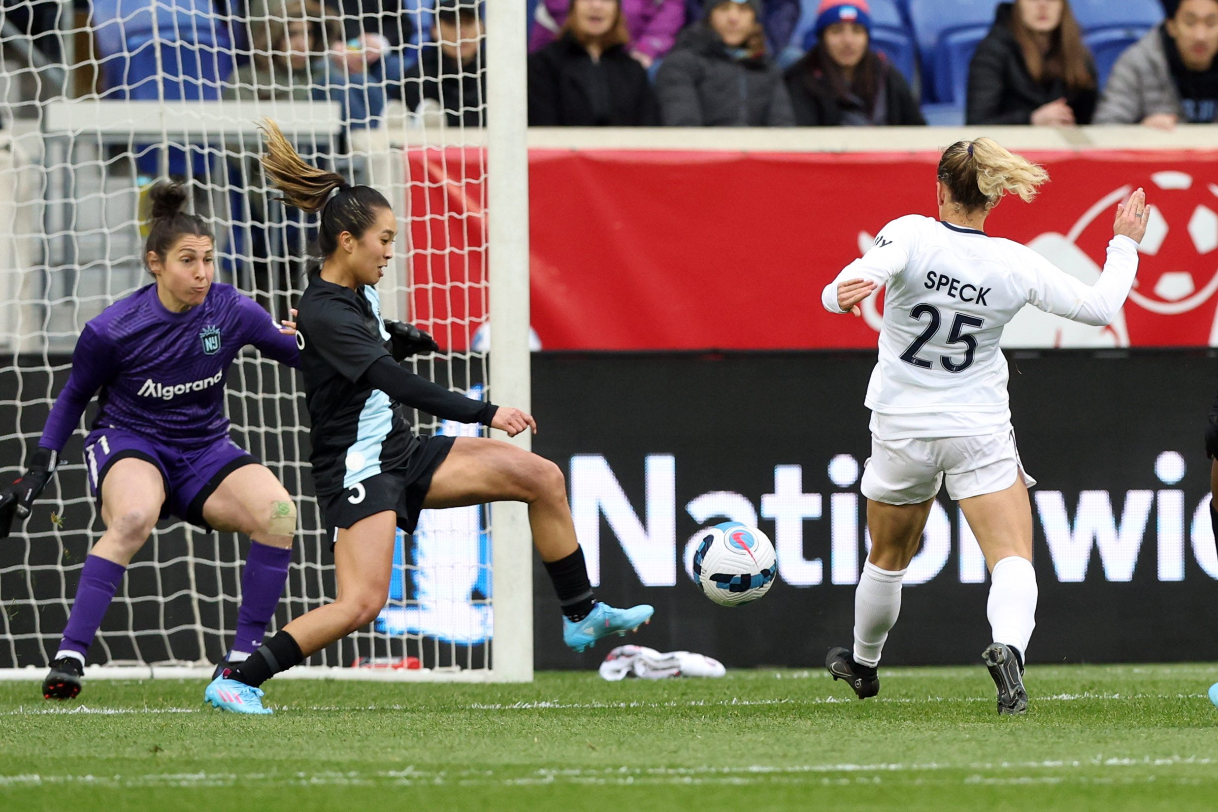 Gotham FC goalkeeper Michelle Betos defends a shot by North Carolina Courage midfielder Meredith Speck.