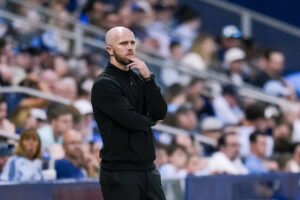 Red Bull New York head coach Michael Bradley observes his team from the technical area.