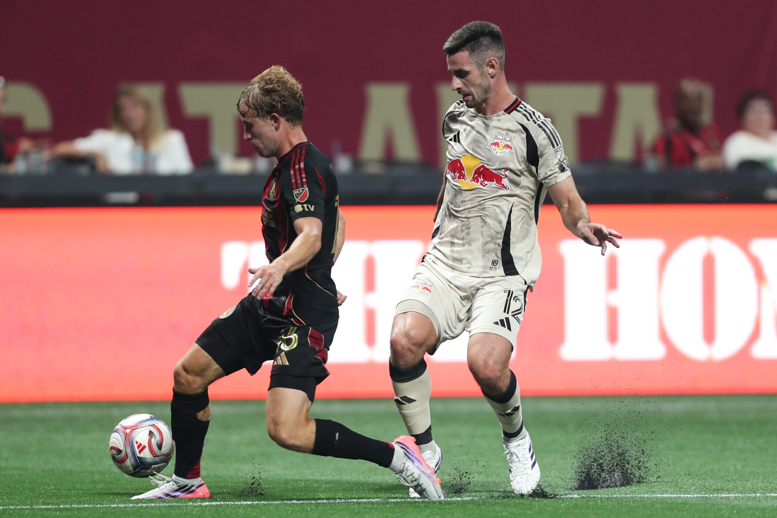 Atlanta United midfielder Adrian Gill dribbles past Red Bull New York defender Dylan Nealis in the first half at Mercedes-Benz Stadium.