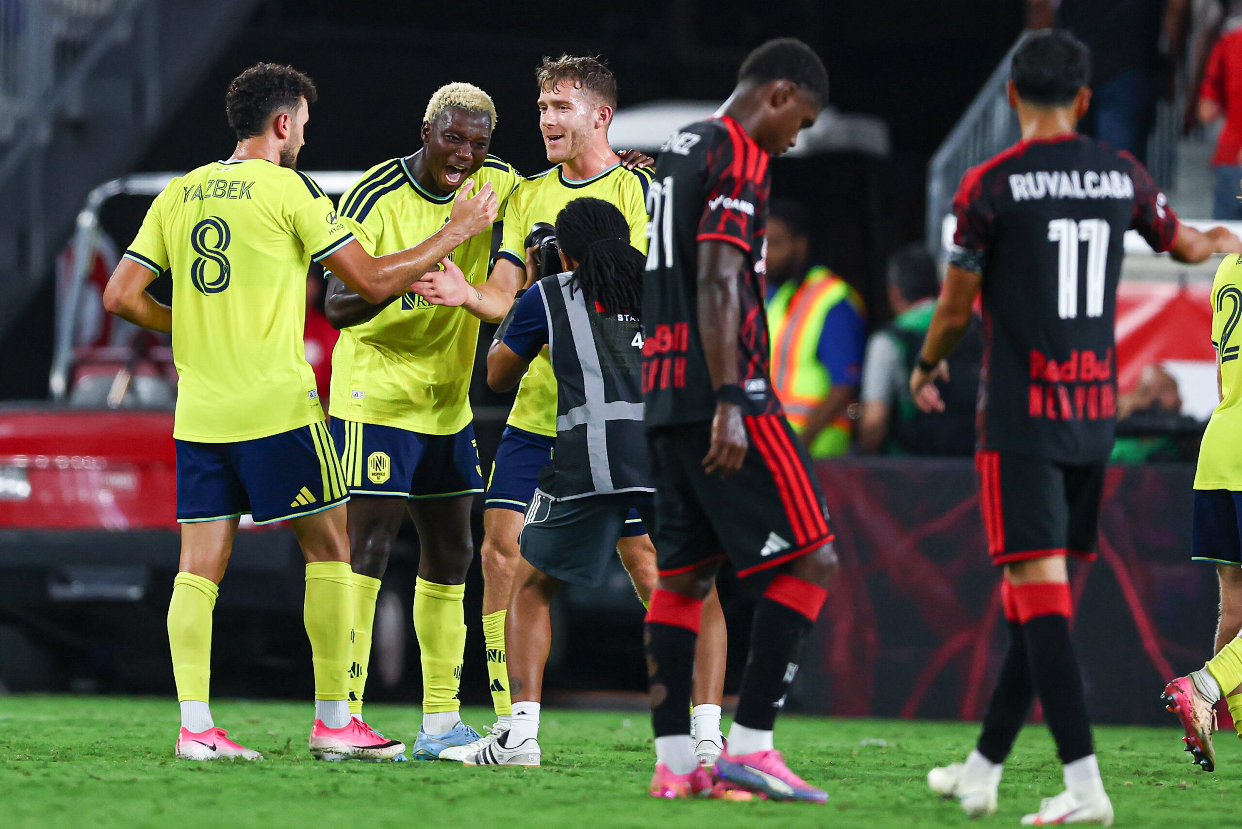 Nashville SC defender Maxwell Woledzi celebrates with teammates after defeating Red Bull New York at Sports Illustrated Stadium.