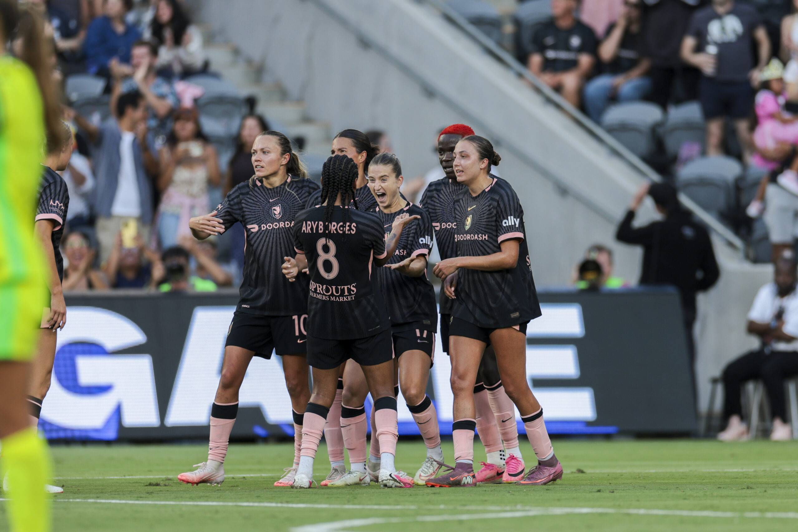Angel City FC teammates celebrate a goal.