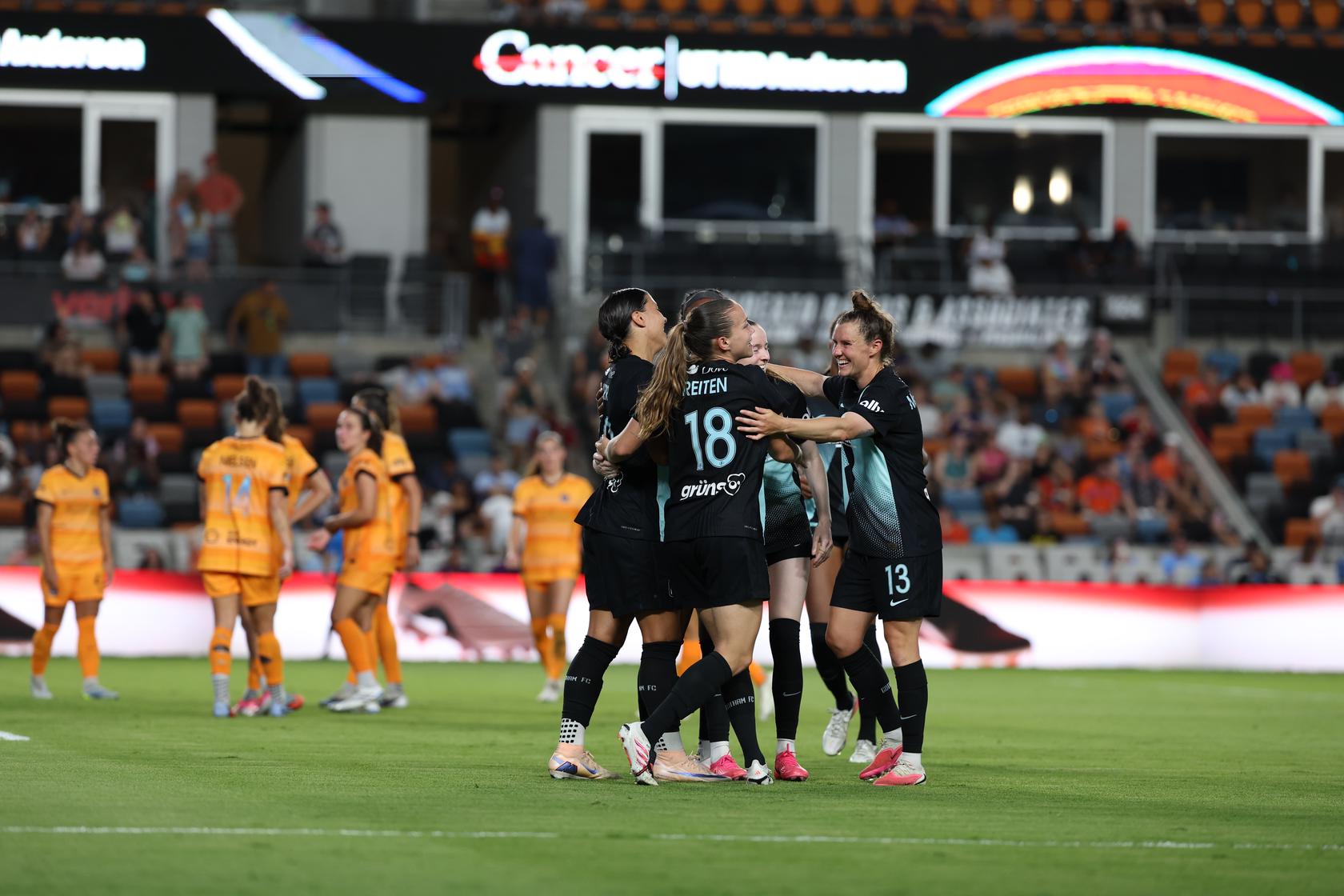 Gotham FC teammates celebrate together.
