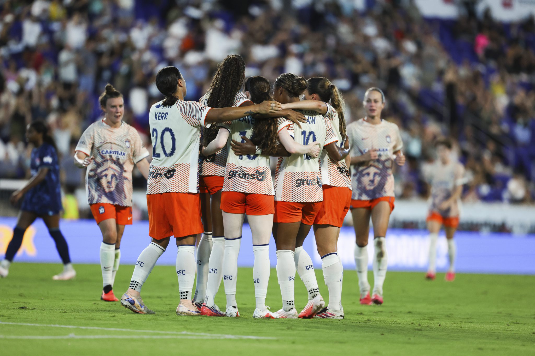 Gotham FC teammates celebrate together.