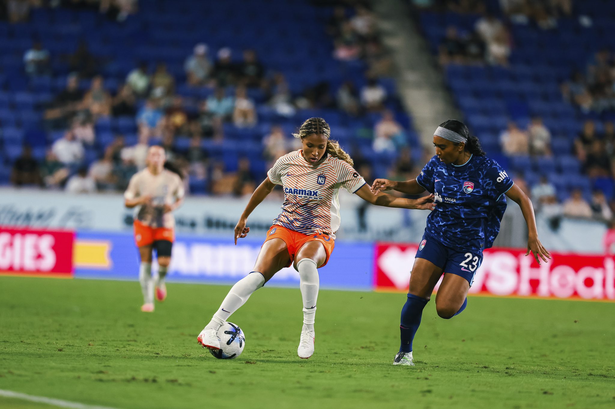 Gotham FC forward Midge Purce shield the ball.