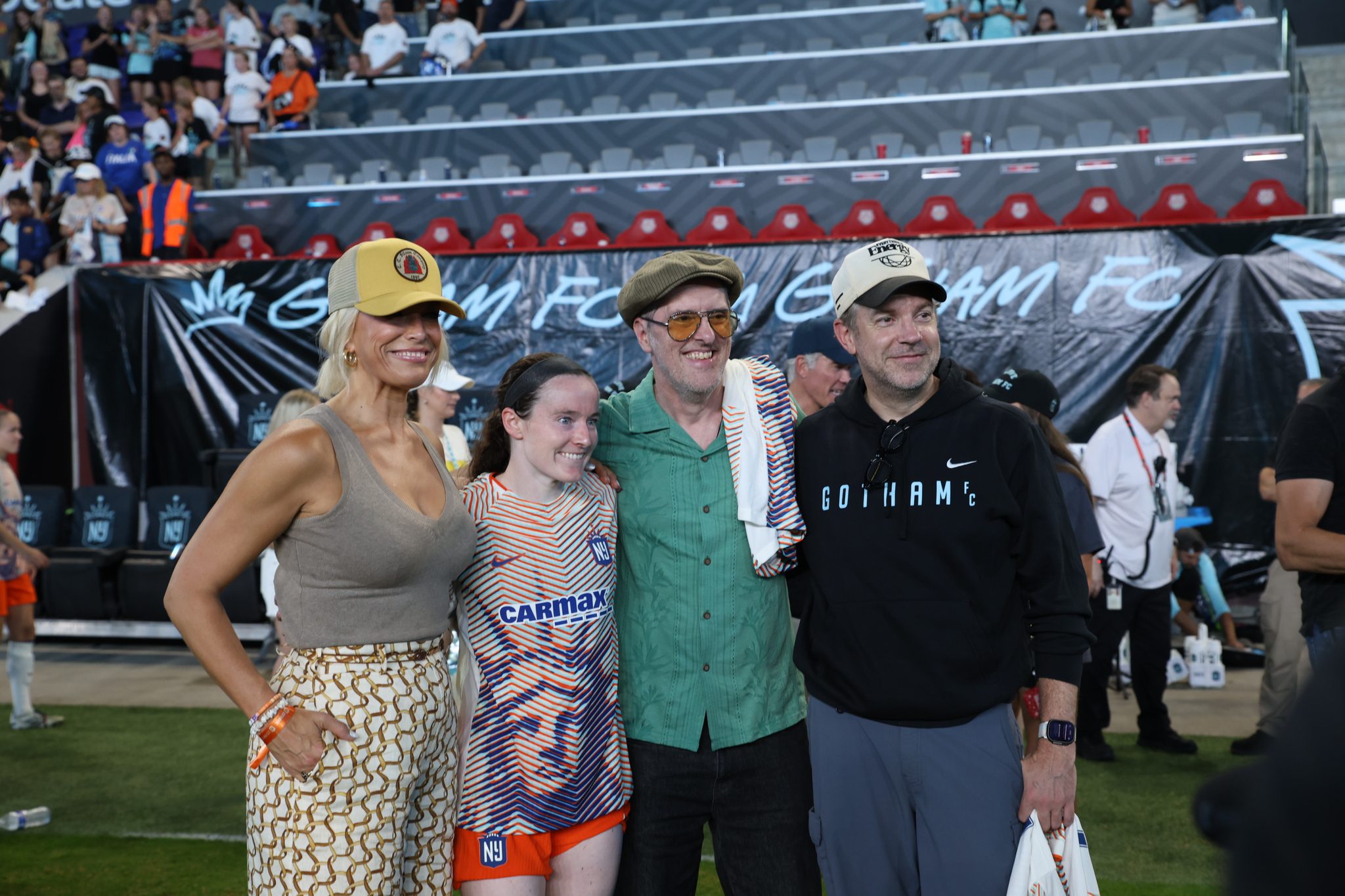 Gotham FC midfielder Rose Lavelle poses with Ted Lasso stars Hannah Waddingham, Brendan Hunt and Jason Sudeikis.
