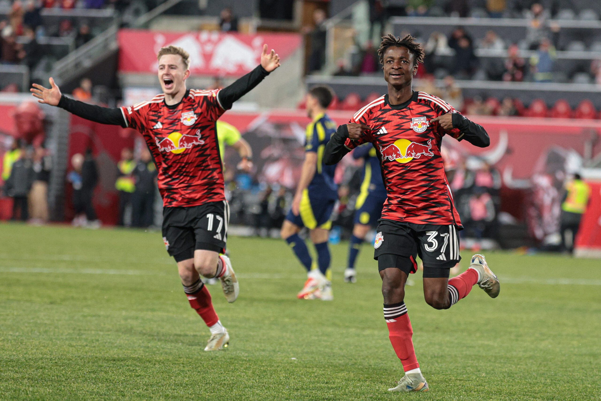 Red Bull New York forward Mohammed Sofo celebrates with forward Cameron Harper after scoring a goal.