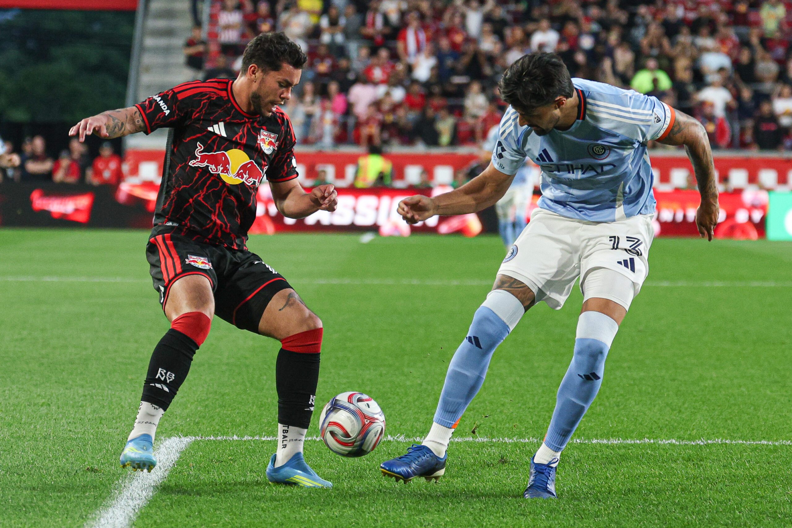 Red Bull New York forward Cade Cowell and New York City FC defender Thiago Martins battle for the ball during the first half at Sports Illustrated Stadium.