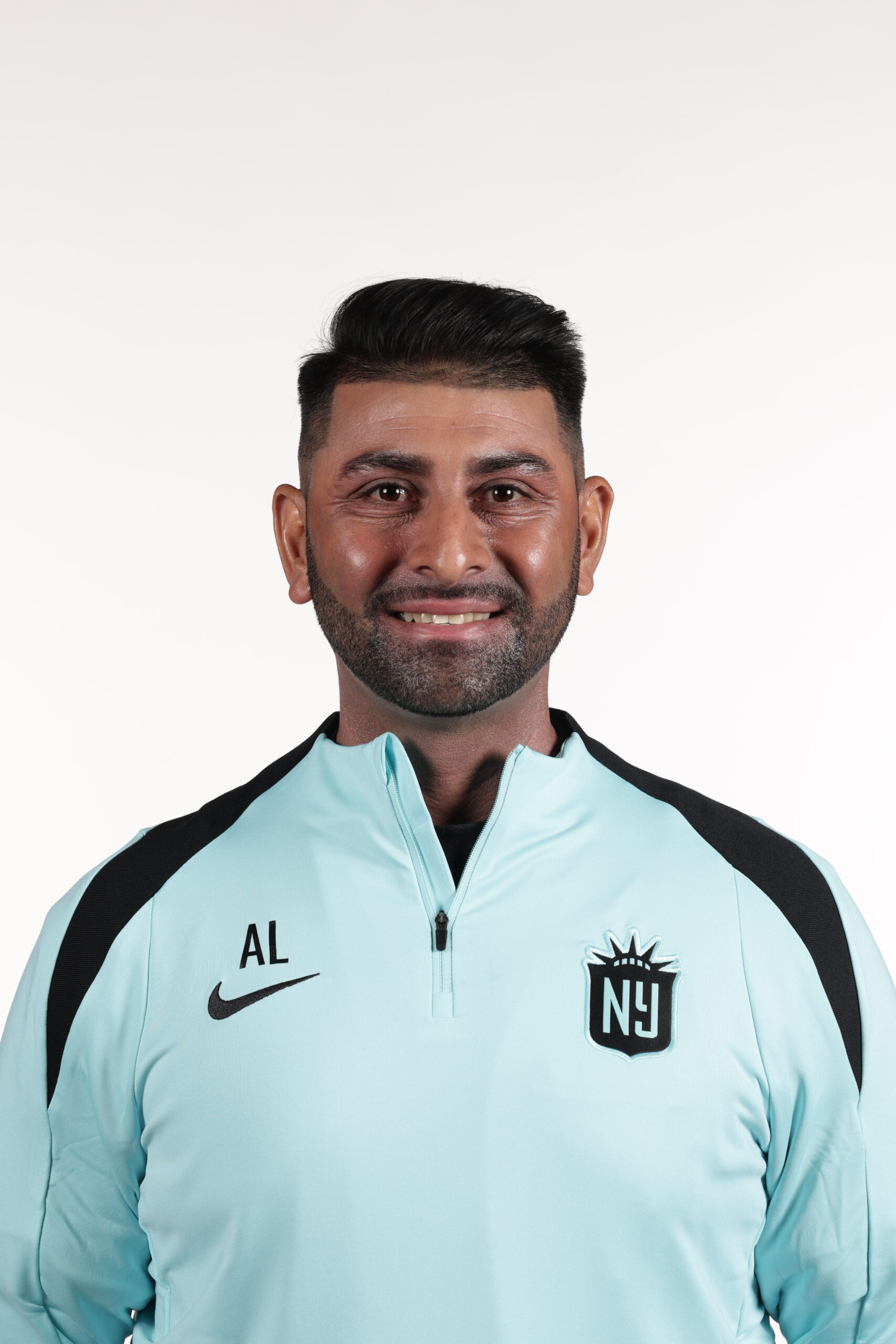 Gotham FC assistant coach Ak Lakhani poses for a photo.
