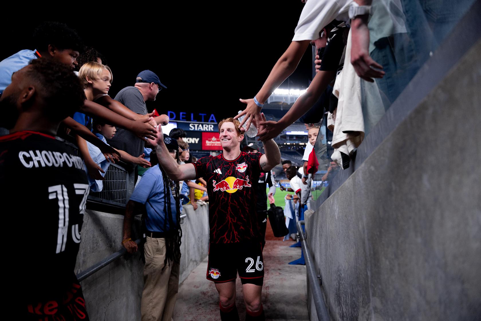 Red Bull New York defender Tim Parker celebrates with supporters.