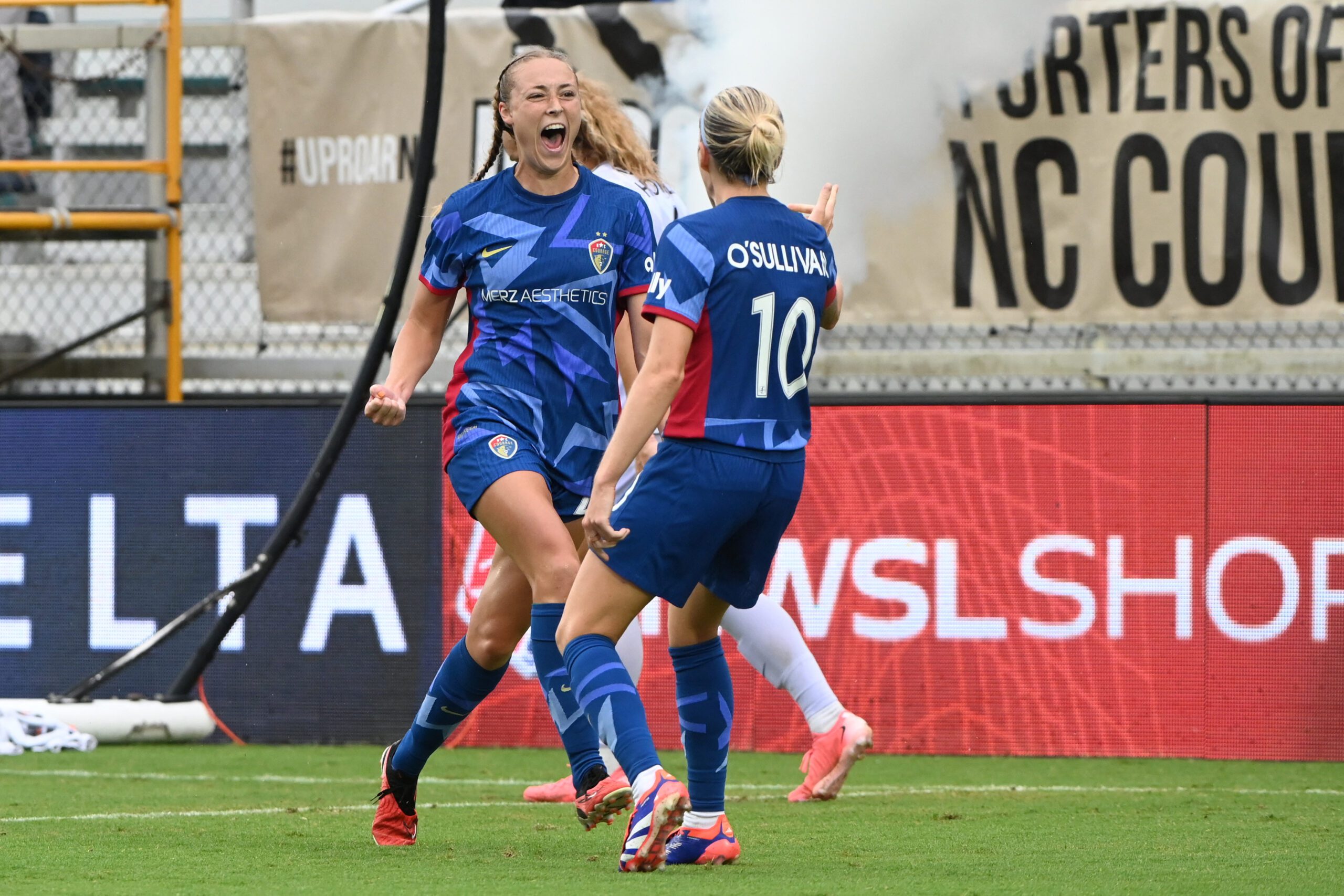North Carolina Courage forward Olivia Wingate celebrates with midfielder Denise O'Sullivan after scoring a goal against Racing Louisville FC.