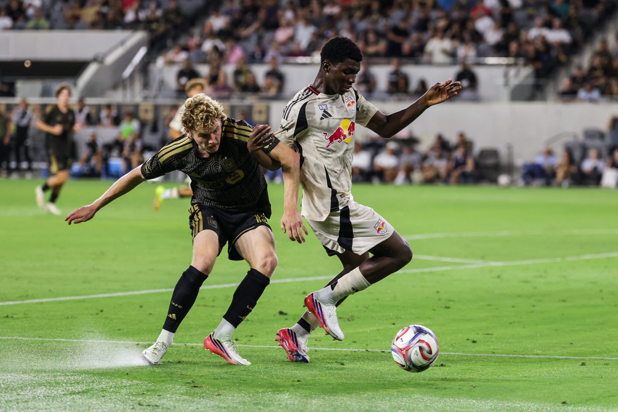Los Angeles FC forward Jacob Shaffelburg and Red Bull New York midfielder Sekou Kone compete for the ball during the second half at BMO Stadium.