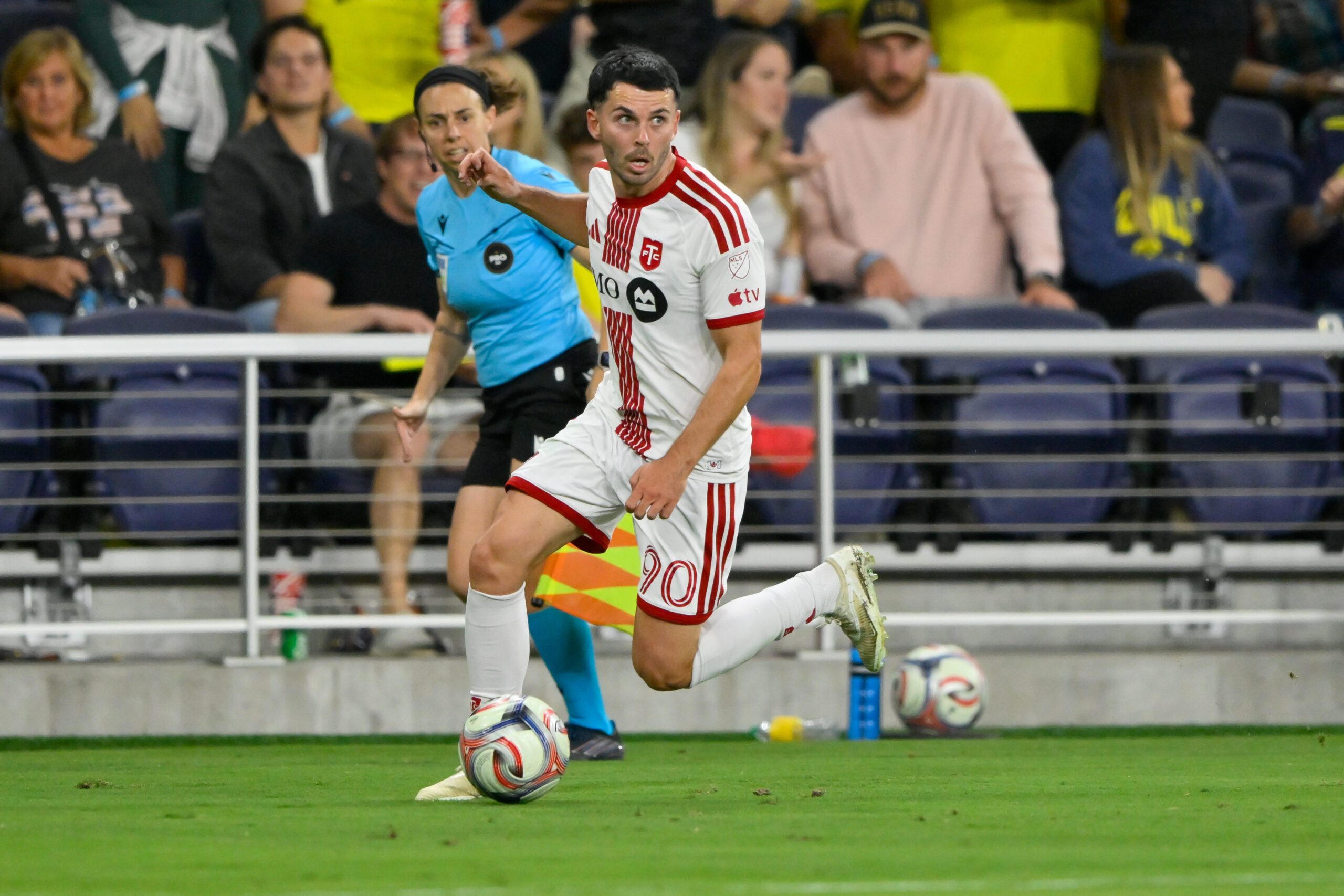 Toronto FC forward Lewis Morgan dribbles the ball against the Nashville SC during the first half at Geodis Park.