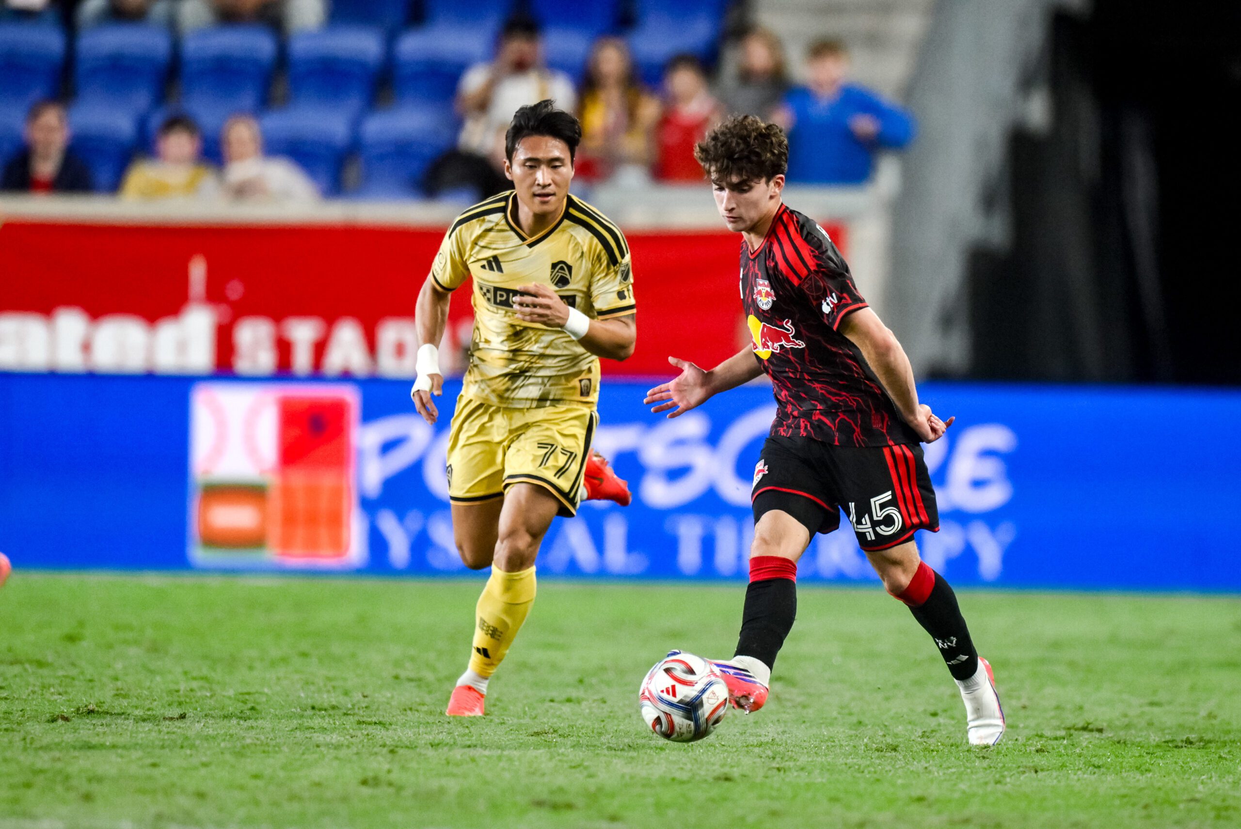 Red Bull New York defender Connor Faello moves the ball past St. Louis CITY SC forward Jeong Sang-Bin during the second half at Sports Illustrated Stadium.