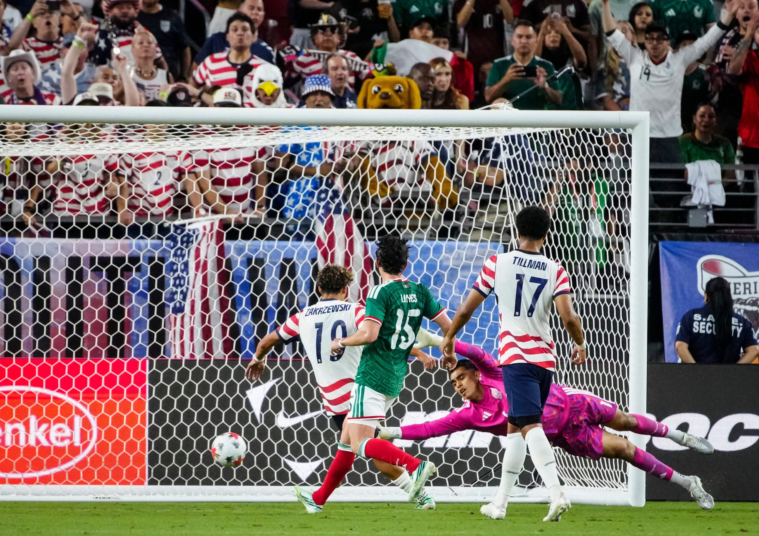 United States men's national team forward Julian Hall scores a goal against Mexico keeper Jose Rangel during an international friendly match at State Farm Stadium. 