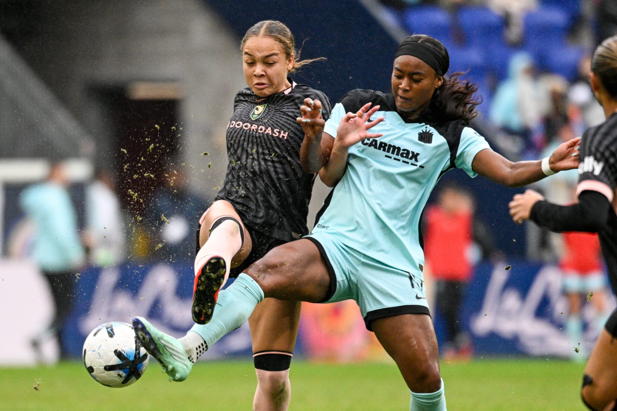 Angel City FC defender Savy King competes for the ball against Gotham FC midfielder Jaedyn Shaw at Sports Illustrated Stadium.