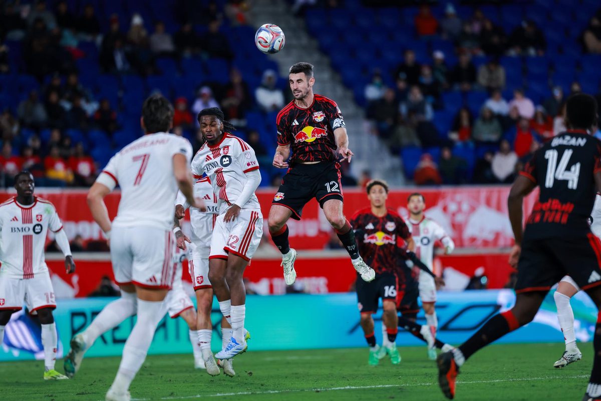 Red Bull New York defender Dylan Nealis rises for a header.